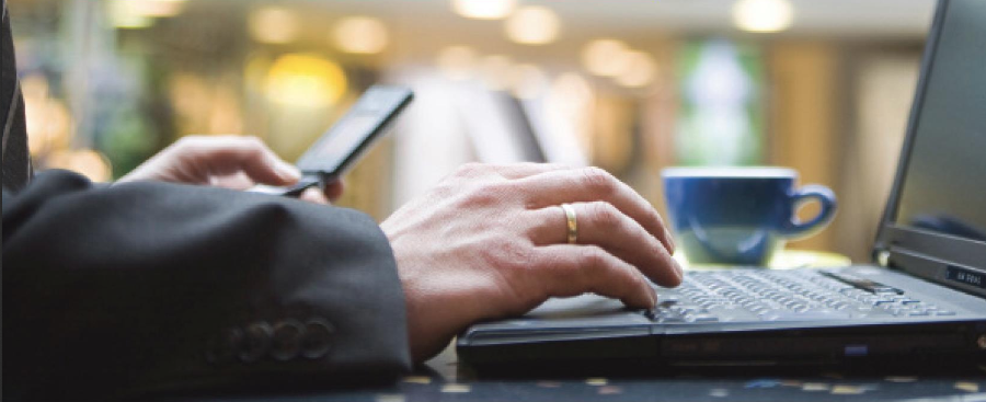 Hands typing on laptop